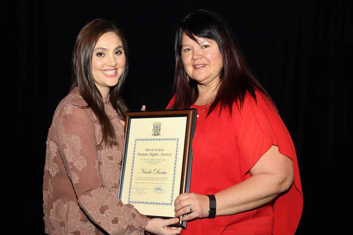 Commissioner Cheryl Knockwood presents award to Nicole Doria