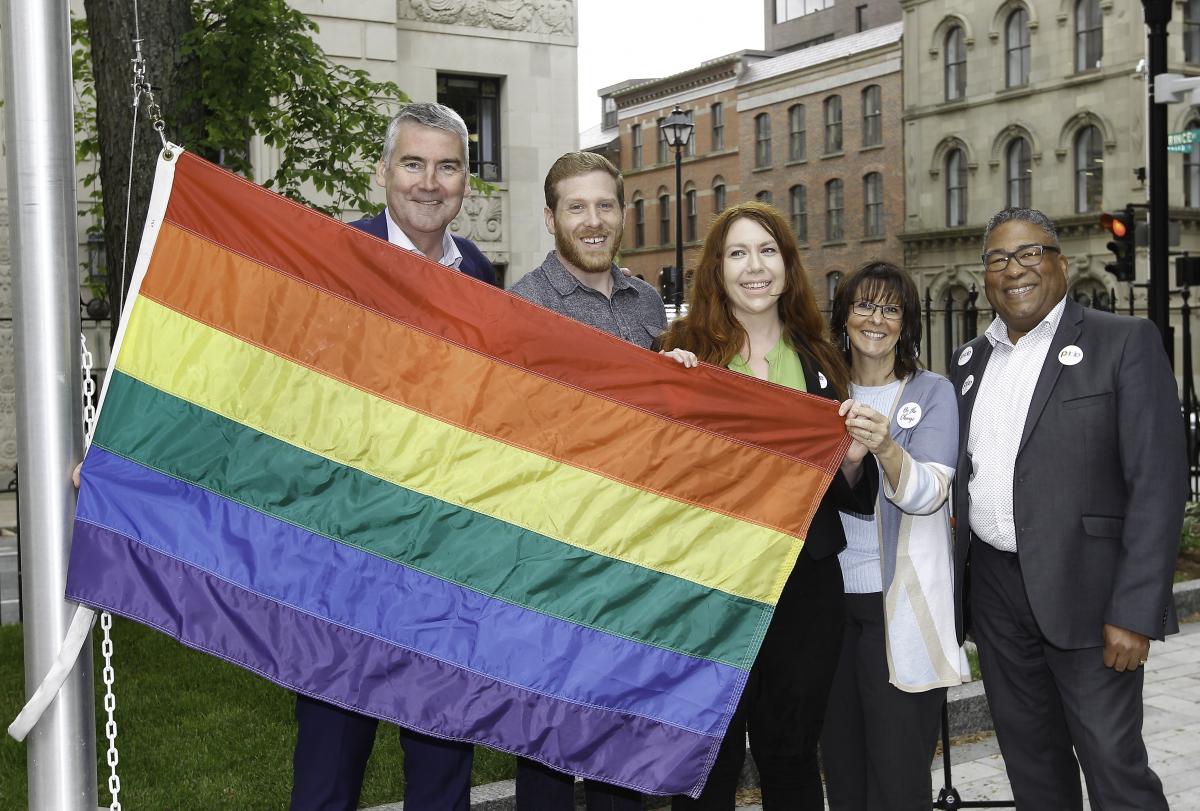 officials at the pride flag raising event