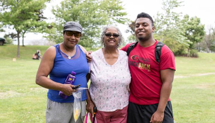 three generations of African Nova Scotians photographed outdoors in Africville Park