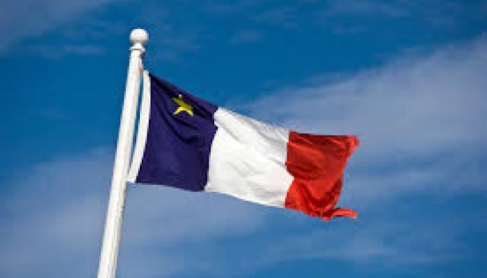an Acadian flag of blue white and red with a gold star on a blue background