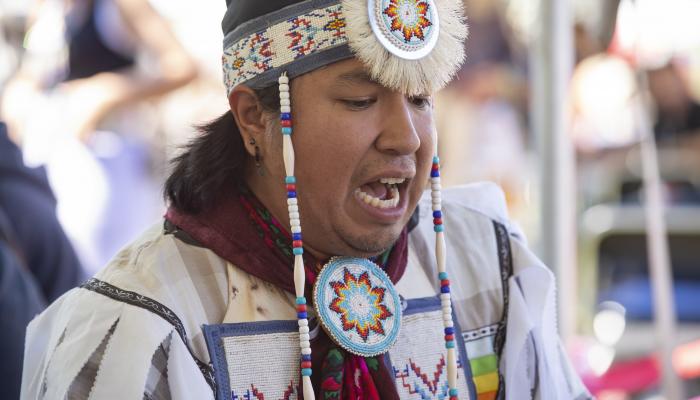 an L'nuy singer wears traditional regalia 