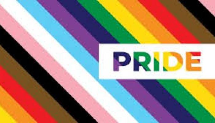 pride on a progressive pride flad coloured background